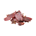 Dried beef jerky pieces on a white background