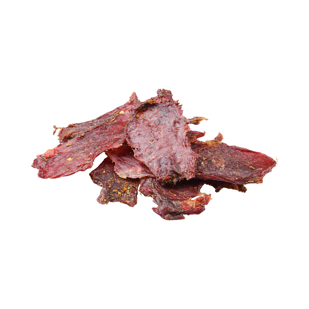 Dried beef jerky pieces on a white background