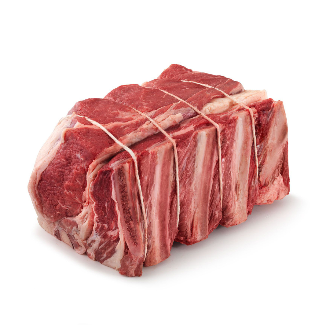 Raw rib roast tied with string on a white background