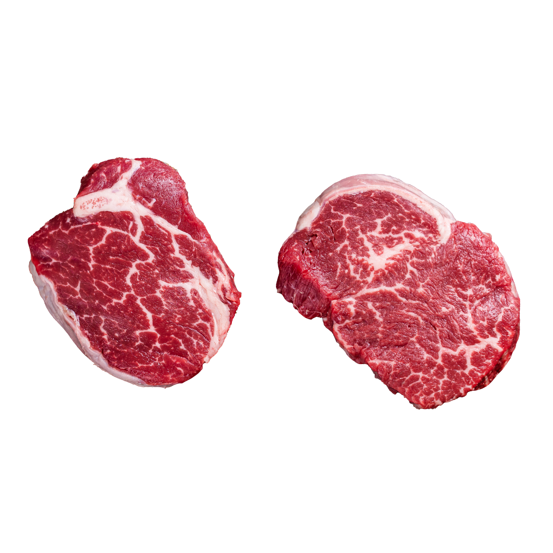 Two raw beef tenderloin pieces on a white background