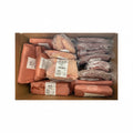 Box containing packages of raw chicken and other meat products with labels.