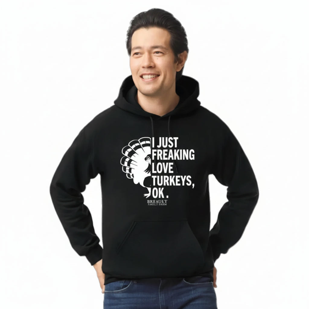 Person wearing a black hoodie with text and graphic design on a transparent background