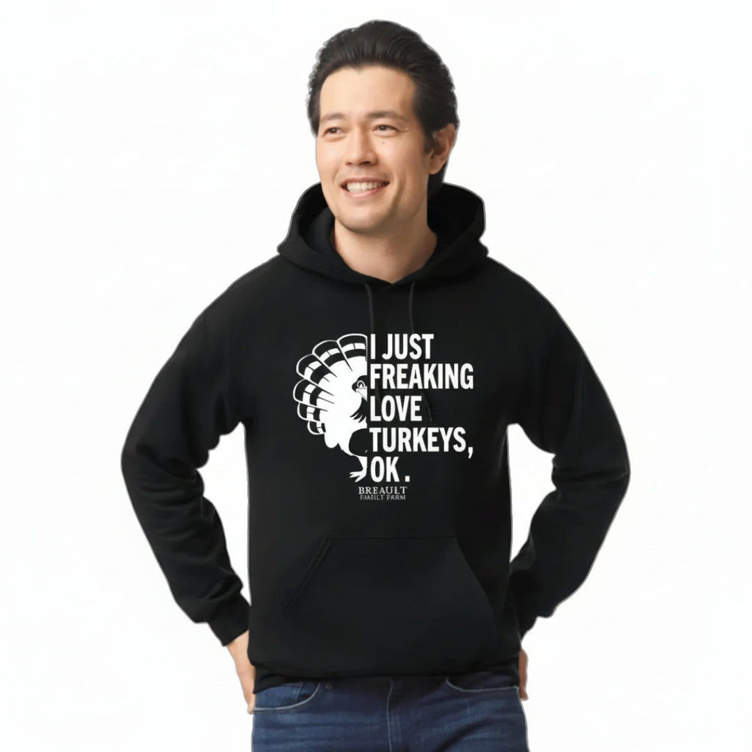 Person wearing a black hoodie with text and graphic design on a transparent background