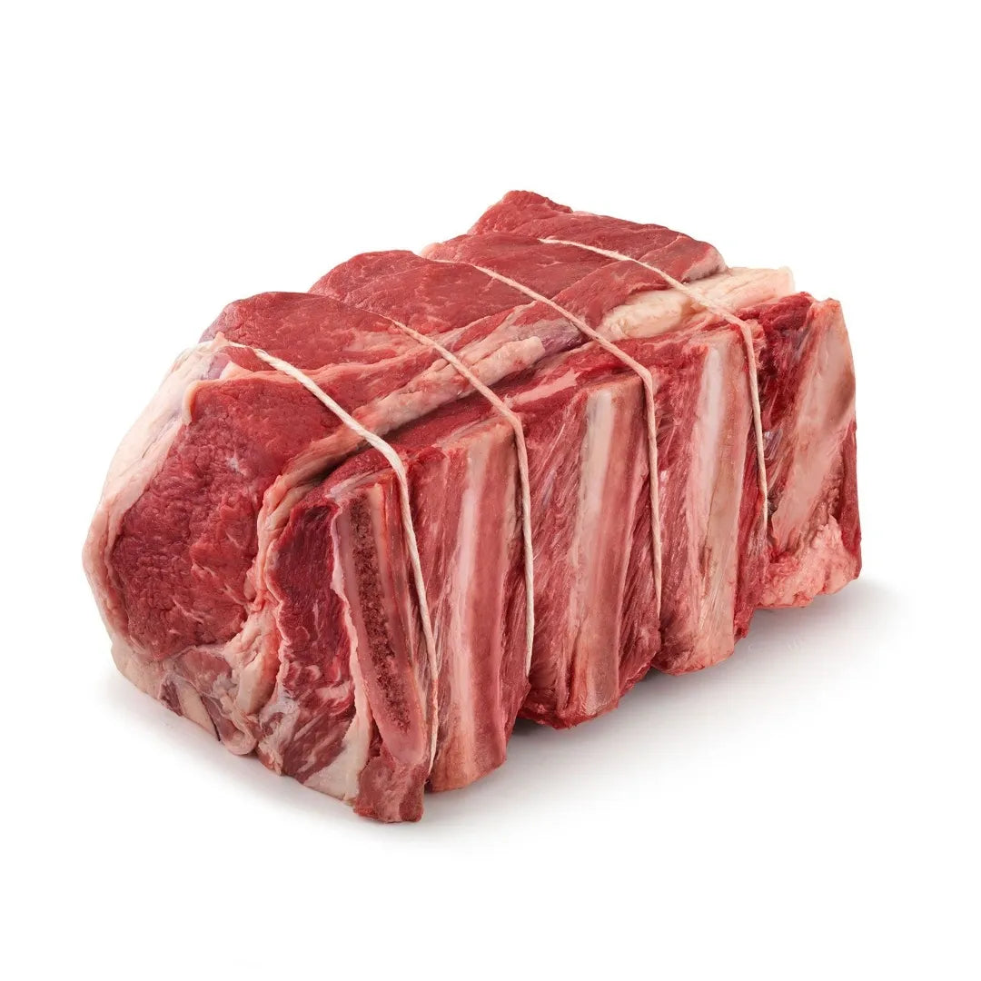 raw bison cross rib roast on a white background