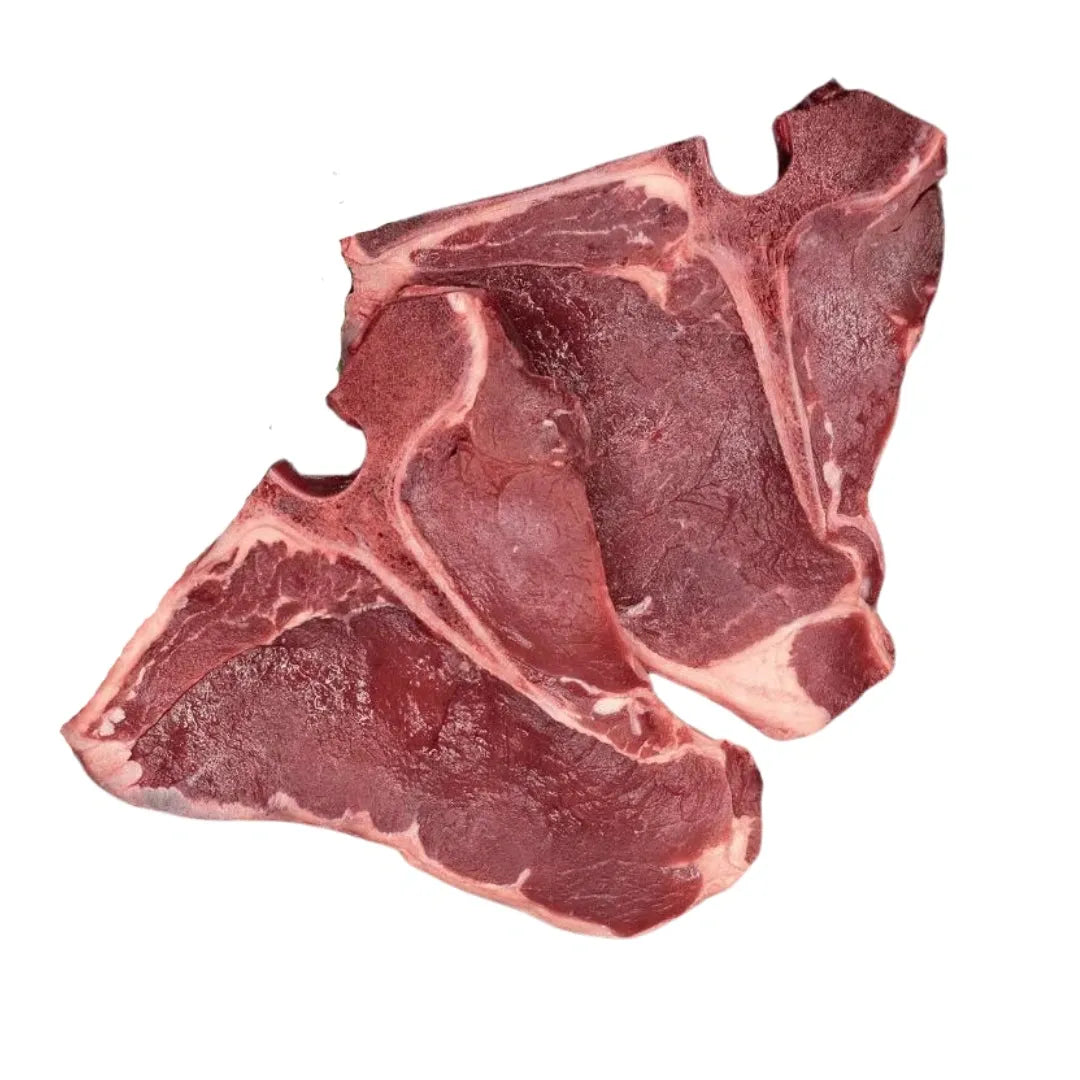 Raw bison t-bone steaks on a white background